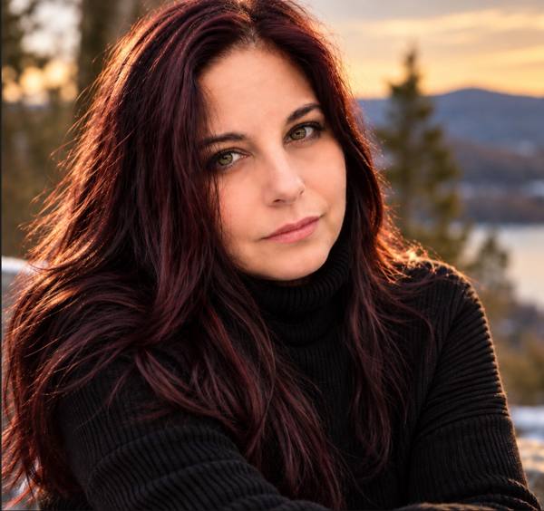 Laureen MacBradaigh outdoors at sunset, wearing a black sweater.